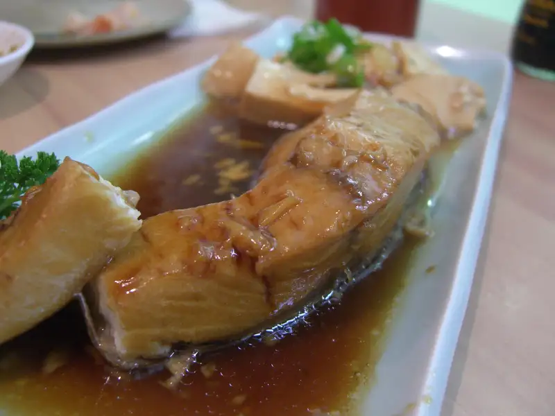 Baked fish, soy sauce, and vegetables