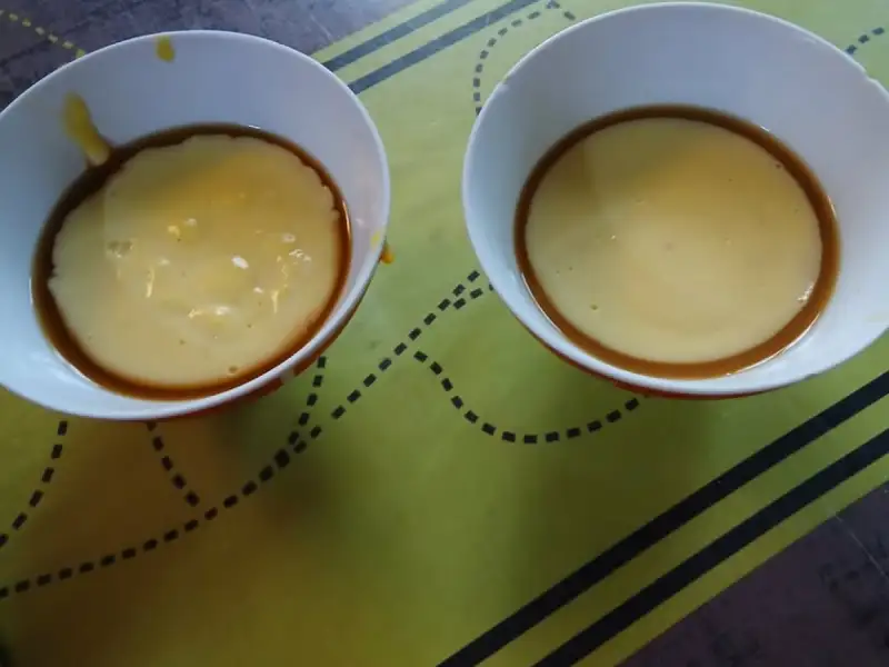 Two caramel custards turned out into white bowls