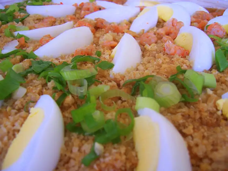Pansit palabok, a noodle dish with a rocou-based sauce and shrimp.