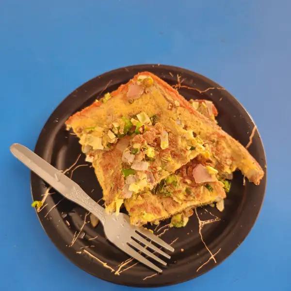 Omelette filled with [insert filling], folded in the style of a traditional bistro