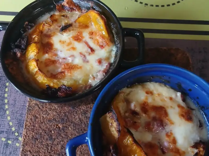 Two ramekins of broiled yellow tomato, mozzarella and bacon